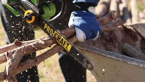 Using a Procraft cordless chainsaw for sawing wood Stock Footage 332945865