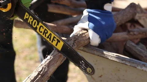Using a Procraft cordless chainsaw for sawing wood Stock Footage 332945866