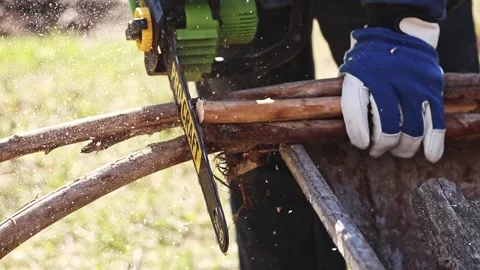 Using a Procraft cordless chainsaw for sawing wood Stock Footage 332945868