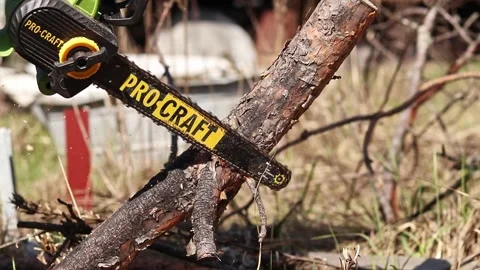 Using a Procraft cordless chainsaw for sawing wood Stock Footage 332946257