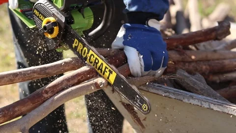 Using a Procraft cordless chainsaw for sawing wood Stock Footage 332946259