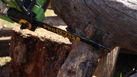 Using a Procraft cordless chainsaw for sawing wood Stock Footage 332946288