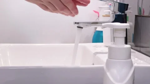 Using a pump dispenser for hand soap in a bathroom sink. Slow motion shot. Video stock 276743130