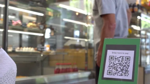 Using QR Codes for Touch-Free Digital Payments. Printed display with QR code Stock Footage 139080751