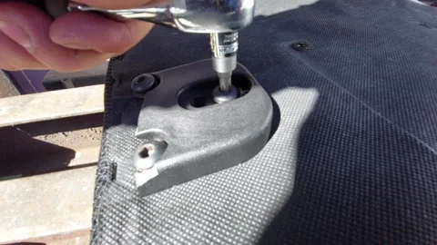 Using a ratchet wrench to unscrew a bolt on a plastic part Stock Footage 334569358