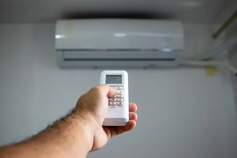 Using Remote Control for Air Conditioning Stock Photos