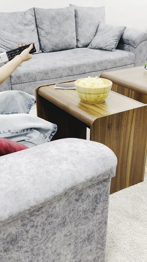 Using remote control and popcorn on a sofa, vertical view Stock Footage 345152524
