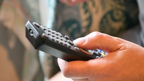 Using the remote control to change channels. Stock Footage 298609108