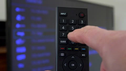 Using a remote control to change the TV channel. Stock Footage 166616678