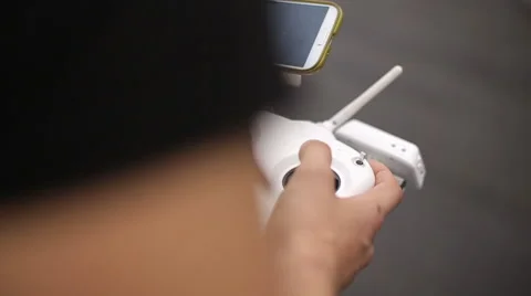 Using remote control to film aerial video with drone mounted camera Stock Footage 62496539
