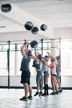 Using the right tools to get into shape. a fitness group working out with Stock Photos