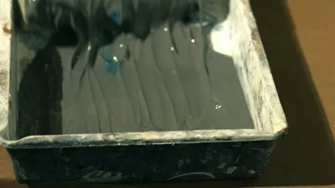 Using a roller in paint tray Stock Footage 244115153