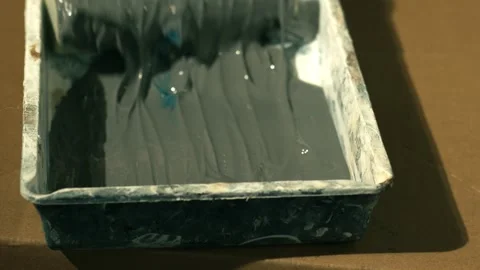 Using a roller in paint tray Stock Footage 246428369
