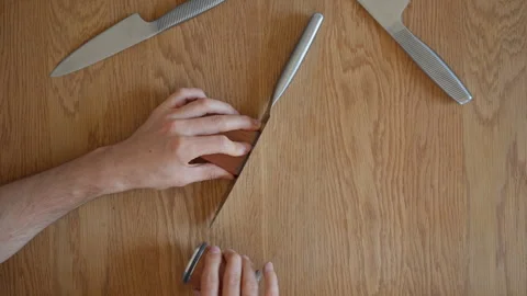Using a rolling knife sharpener for simple and easy knife sharpening at home Stock Footage 315209554