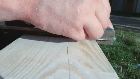 Using a ruler, the worker marks the dimensions with a pencil. Yellow tape Stock Footage 167691470