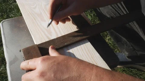 Using a ruler, the worker marks the dimensions with a pencil. Yellow tape Stock Footage 168484267