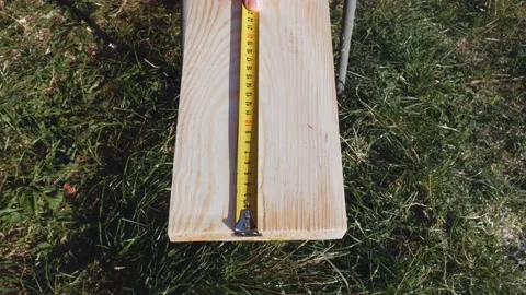 Using a ruler, the worker marks the dimensions with a pencil. Yellow tape Stock Footage 194453699