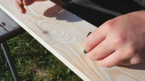 Using a ruler, the worker marks the dimensions with a pencil. Yellow tape Stock Footage 196420165
