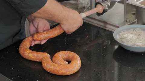 Using a sausage stuffer to make Hungarian sausage. Video stock 140586483