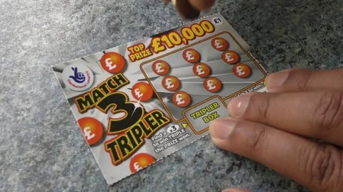 Using scratch card Stock Footage 77576057