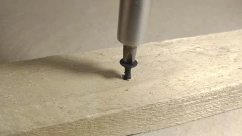 Using screwdriver and screwing screw in a wooden board. Closeup Stock Footage 233290429