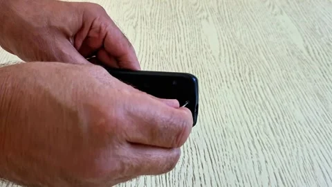 Using Screwdriver to Open TV Remote Control Battery Cover Safely Stock Footage 340746782