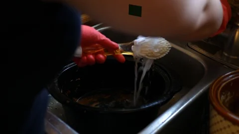 Using a scrubbing brush to wash a crock pot in a sink Stock Footage 106424492