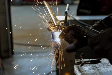 Using a semi-automatic argon gas shielded welding machine, the worker is welding Stock Photos