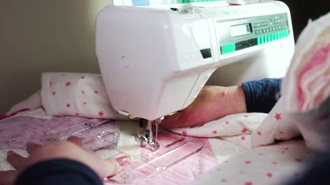 Using a sewing machine fitted with a plastic template to stitch a pattern Stock Footage 168421108