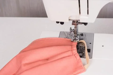 Using the sewing machine to sew the face mask during.the coronavirus pandemia Stock Photos