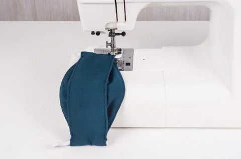 Using the sewing machine to sew the face mask during.the coronavirus pandemia Stock Photos