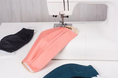 Using the sewing machine to sew the face mask during.the coronavirus pandemia Stock Photos