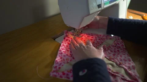 Using a sewing machine to stitch together the pattern on a quilt block - Stock Footage 167623250