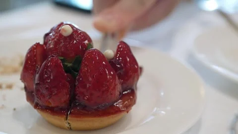 Using silver knife to cut fresh sweet strawberry tart pie for afternoon tea.. Stock Footage 276353189