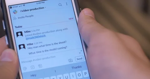 Using Slack App to Message Coworkers on Phone Stock Footage 113285185