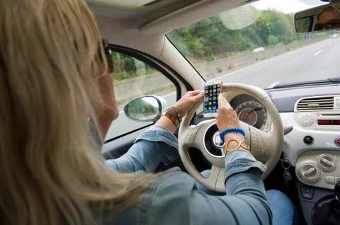 Using smarphone while driving Stock Photos