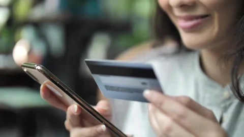 Using smart cell phone for online shopping with credit card on living room Stock Footage 265932001