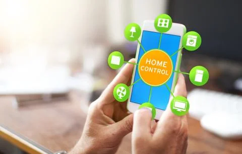 Using smart home app on phone. Smart home control concept. Stock Photos