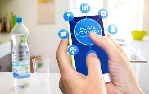Using smart home app on phone. Smart home control concept. Stock Photos