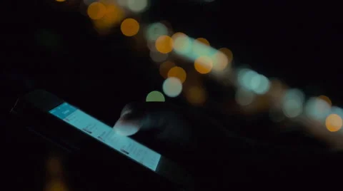 Using smart phone on background of night city lights 動画素材 67436005