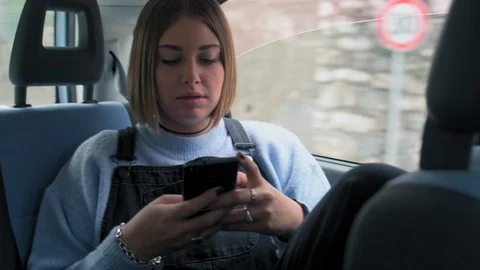 Using smart phone in car 스톡 동영상 129924172