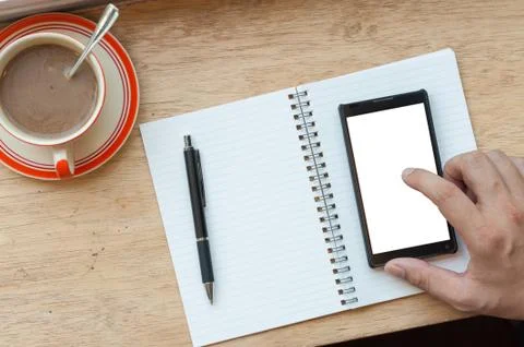 Using smart phone with coffee cup Stock Photos
