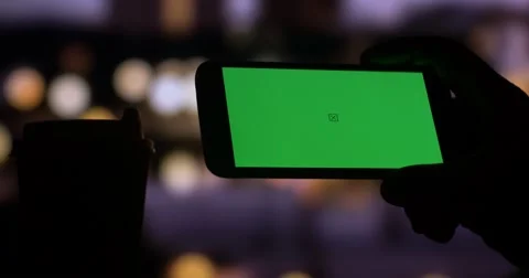 Using smart phone with Green Screen city night bokeh background Video stock 54098888