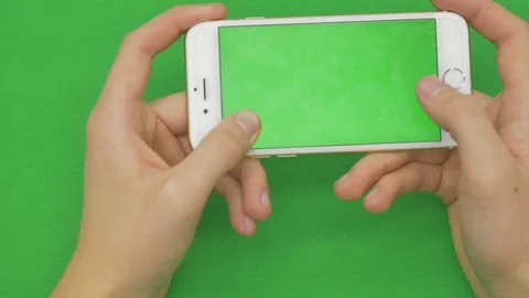 Using smart phone on green screen with various hand gestures, horizontally Stock Footage 83647587