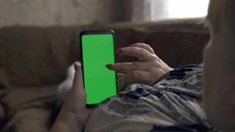 Using smart phone with green screen. hands scrolling pages, tapping on touch scr Stock Footage 151470362