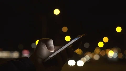 Using Smart Phone on Night Street 1 Stock Footage 75614268