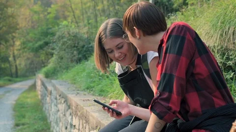 Using smart phone outdoors 스톡 동영상 129924096