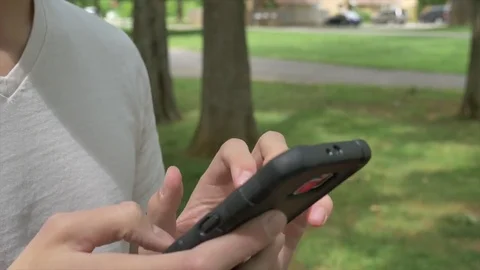 Using a smart phone outside 스톡 동영상 76452680