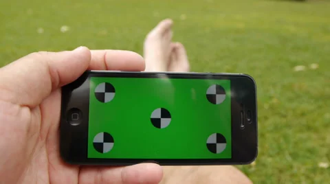 Using a smart phone at the park. Chroma Key Stock Footage 33340909