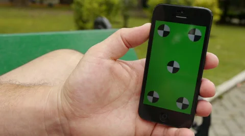 Using a smart phone at the park. Chroma Key Stock Footage 33343015